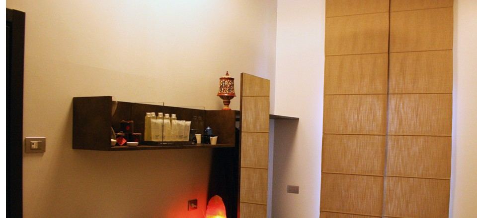 Cabina con mensola di prodotti e lampada di sale accesa
